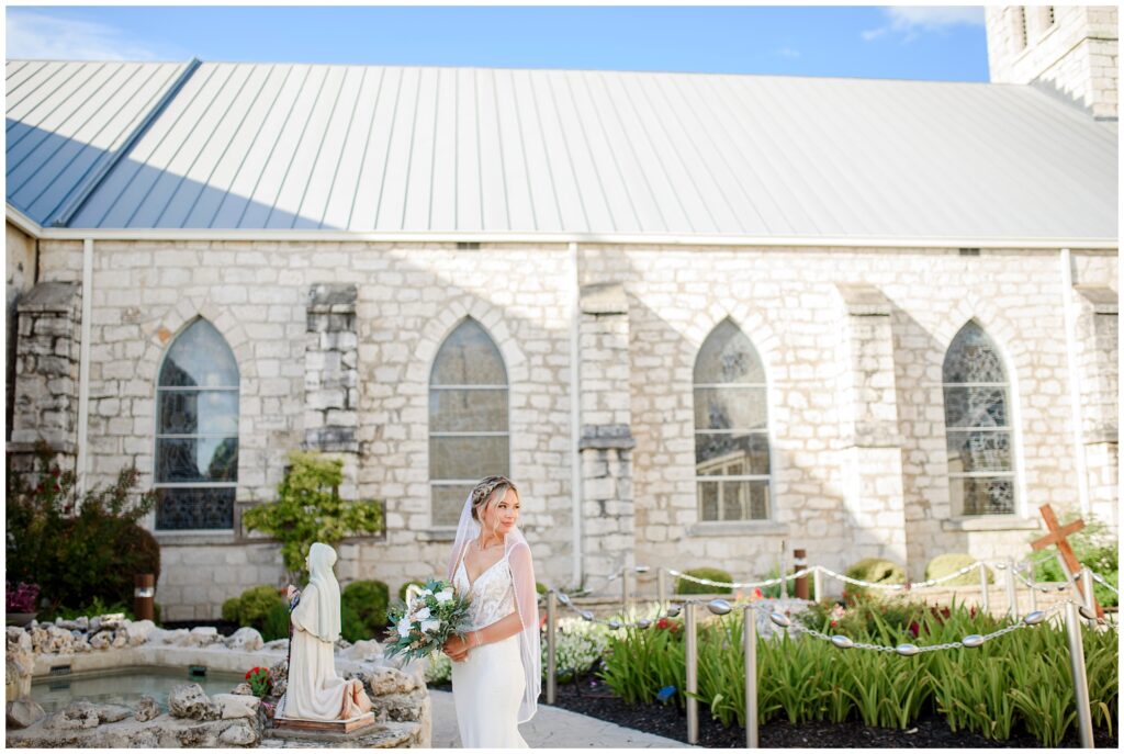 Bride posing in front of limestone arches during her New Braunfels bridal session