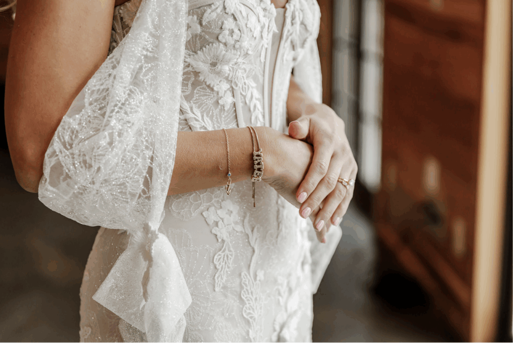 Bride standing in window light during winter wedding light photography